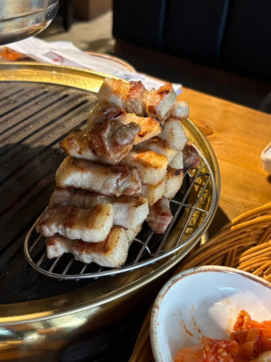 A piece of aged pork belly dipped in salt