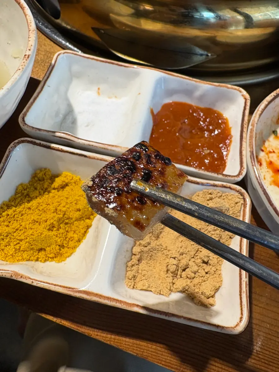 Pork skin served with roasted grain powder and turmeric powder