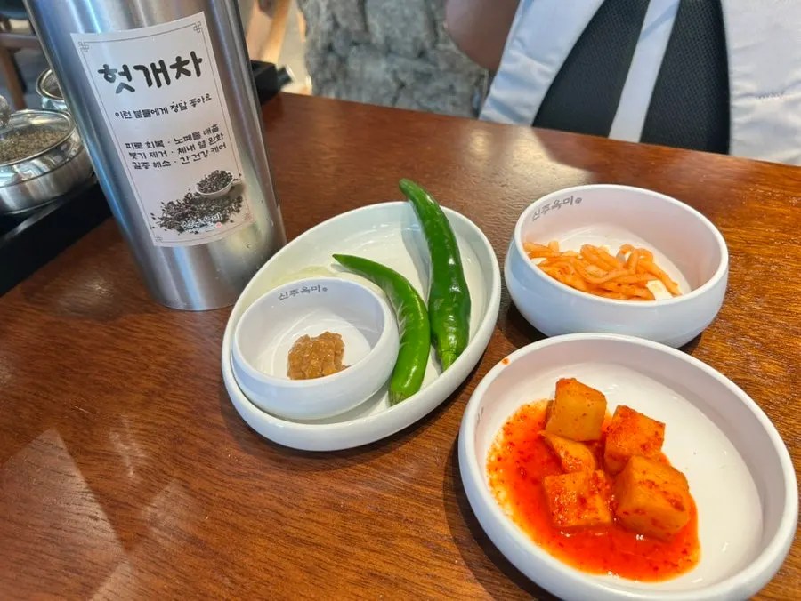 Menu board listing pork gukbap and side dishes