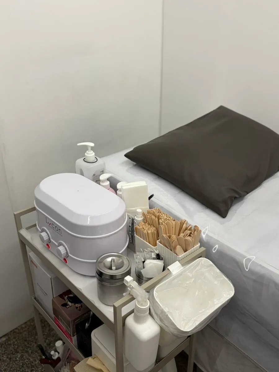 Brazilian waxing treatment bed and hanger