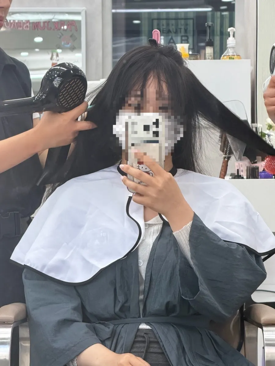 Hair lightly blow-dried with hair oil applied