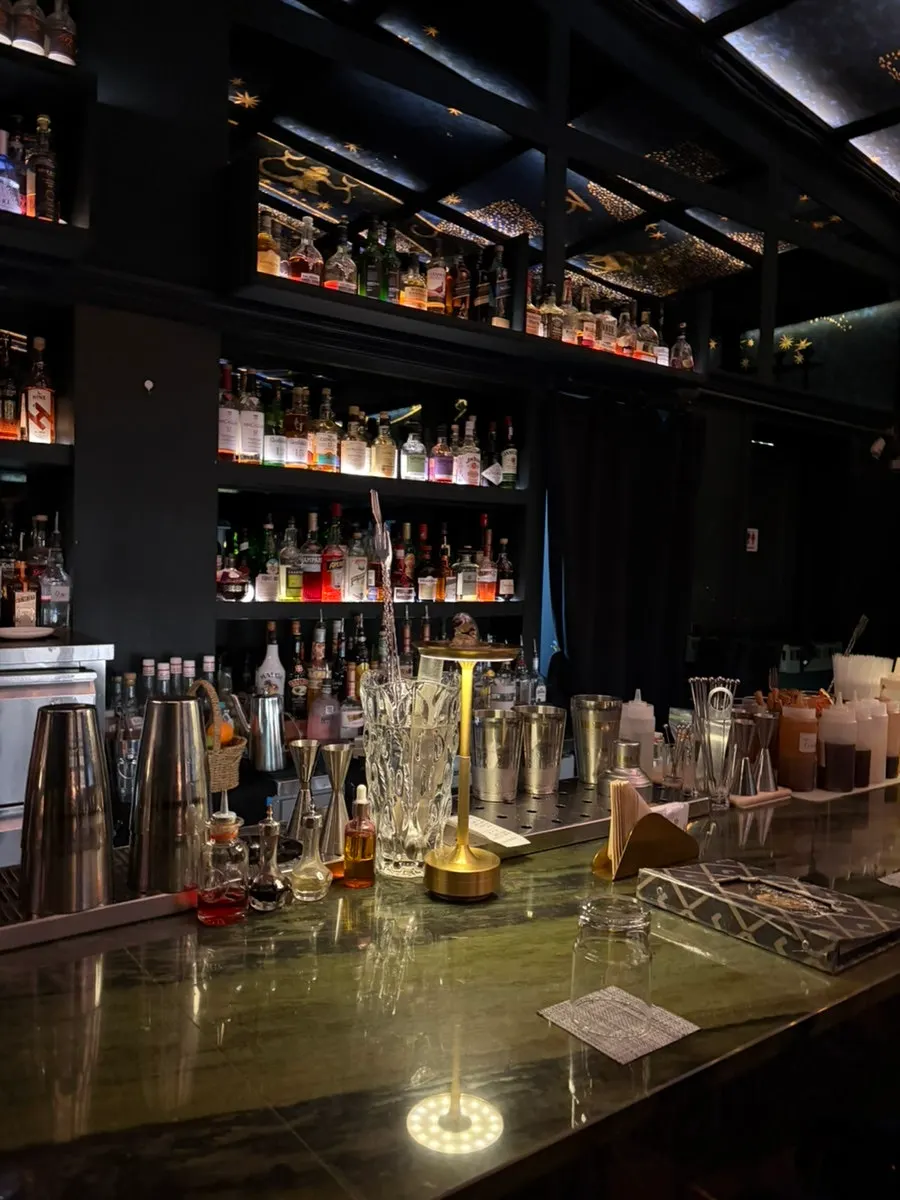Interior view with bartenders making cocktails