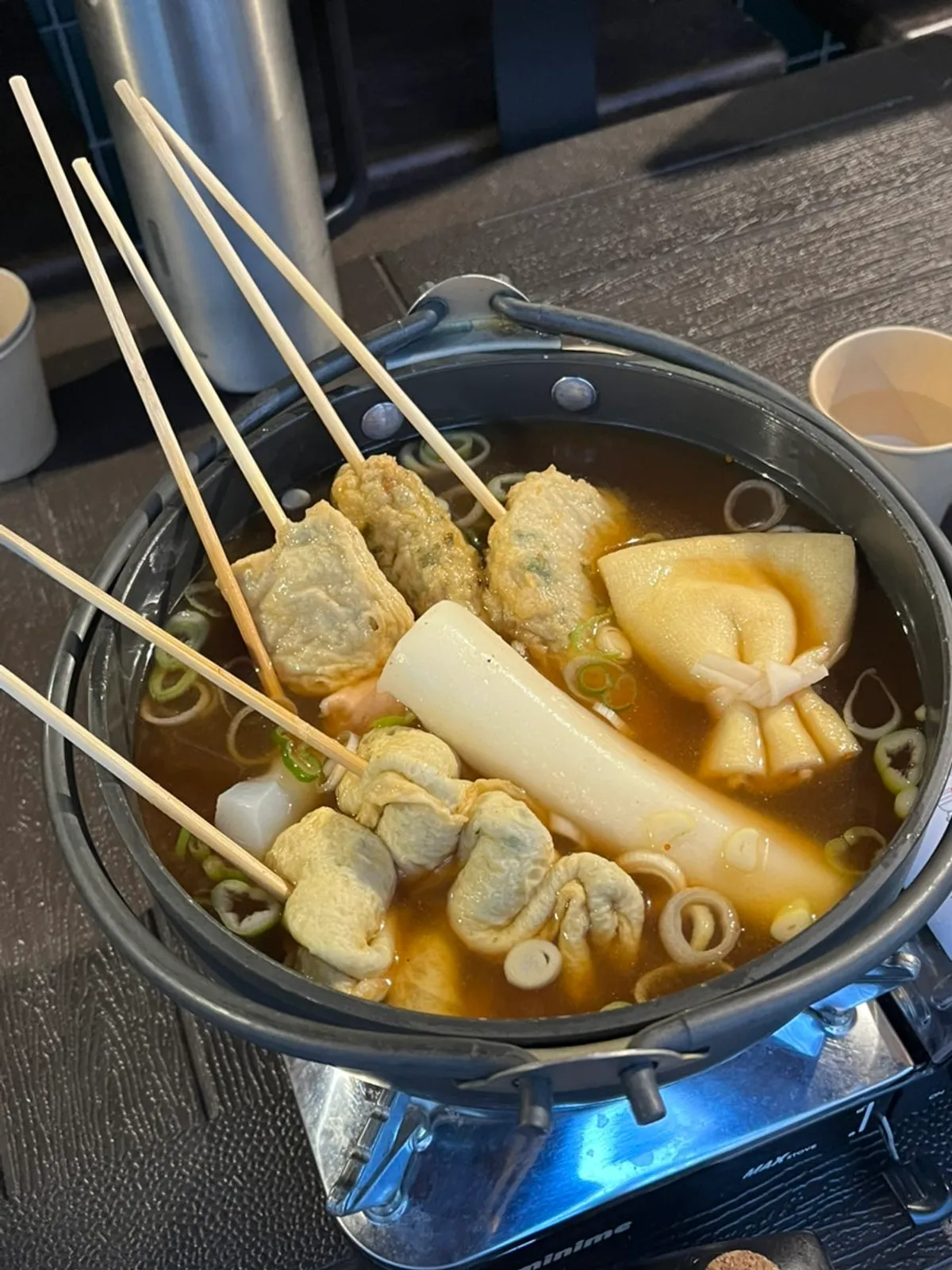 Table spread of oden soup with tuna crackers