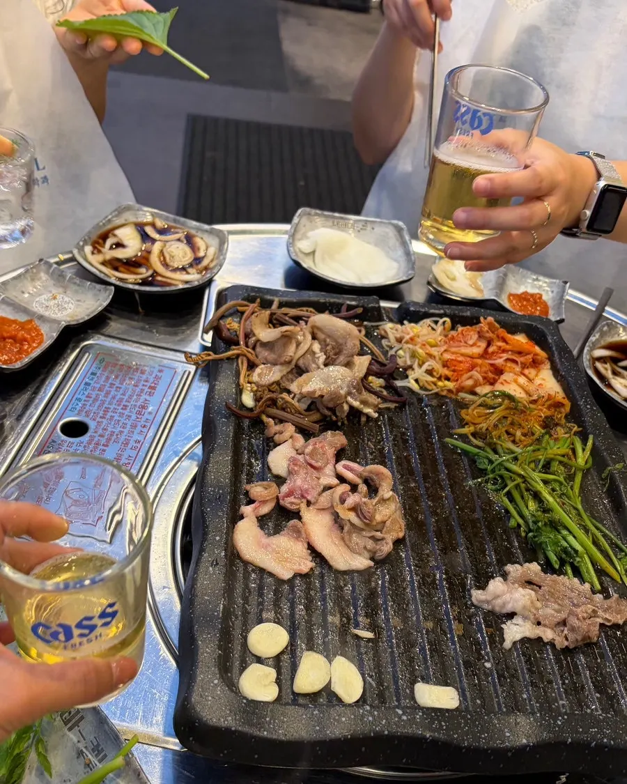 Thin-sliced pork cheek cooking quickly on the grill