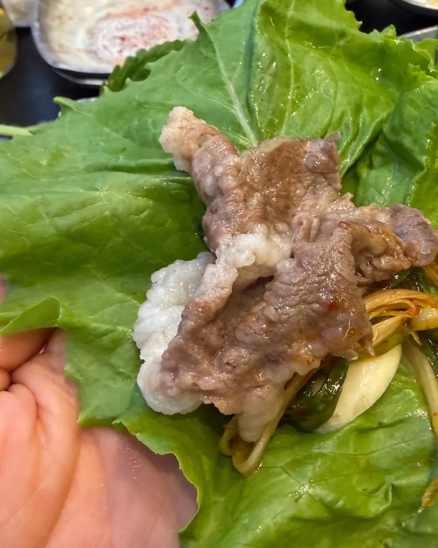 Close-up of thin-sliced meat cooking