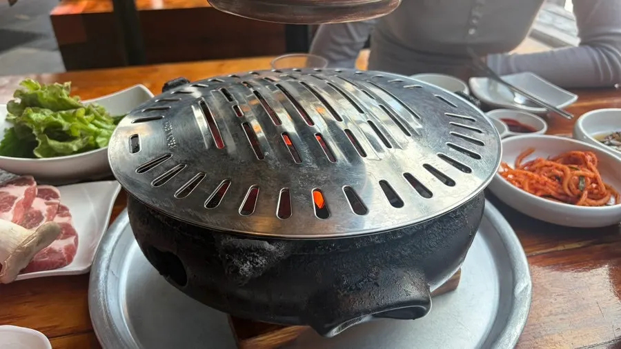 Meat grilling over a charcoal brazier