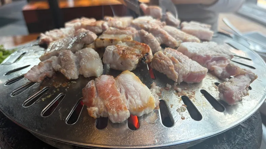 Charcoal-grilled meat browning nicely