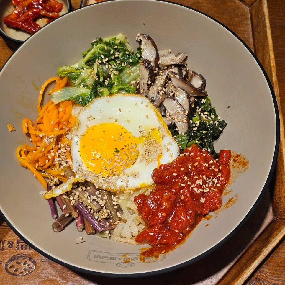 Seasoned beef tartare Jeonju bibimbap topped with soft-boiled egg