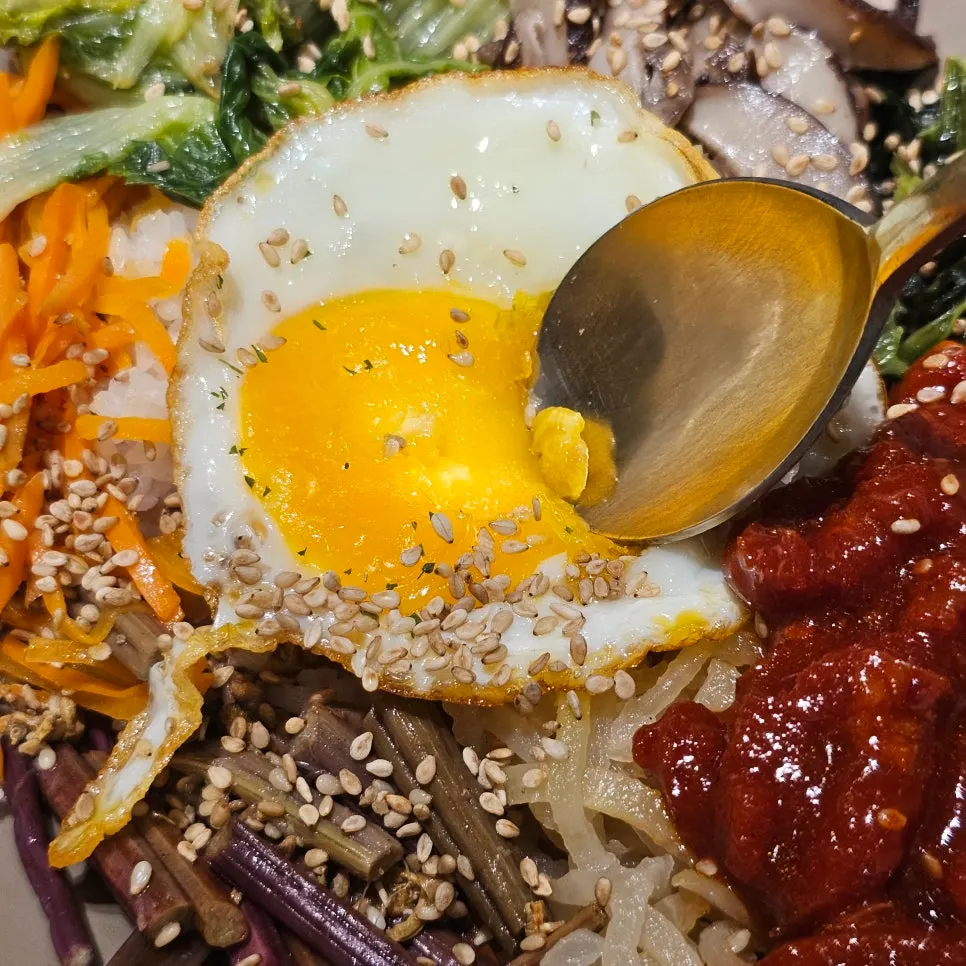Vividly colored vegetables and beef tartare in the bibimbap