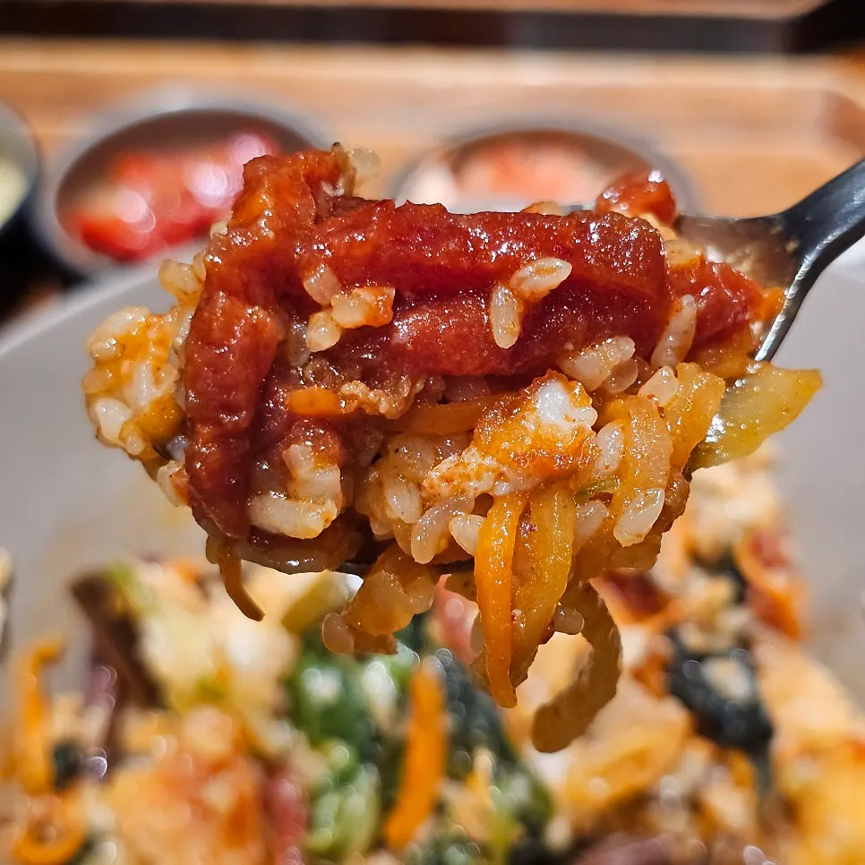 Beef tartare bibimbap mixed with a burst yolk