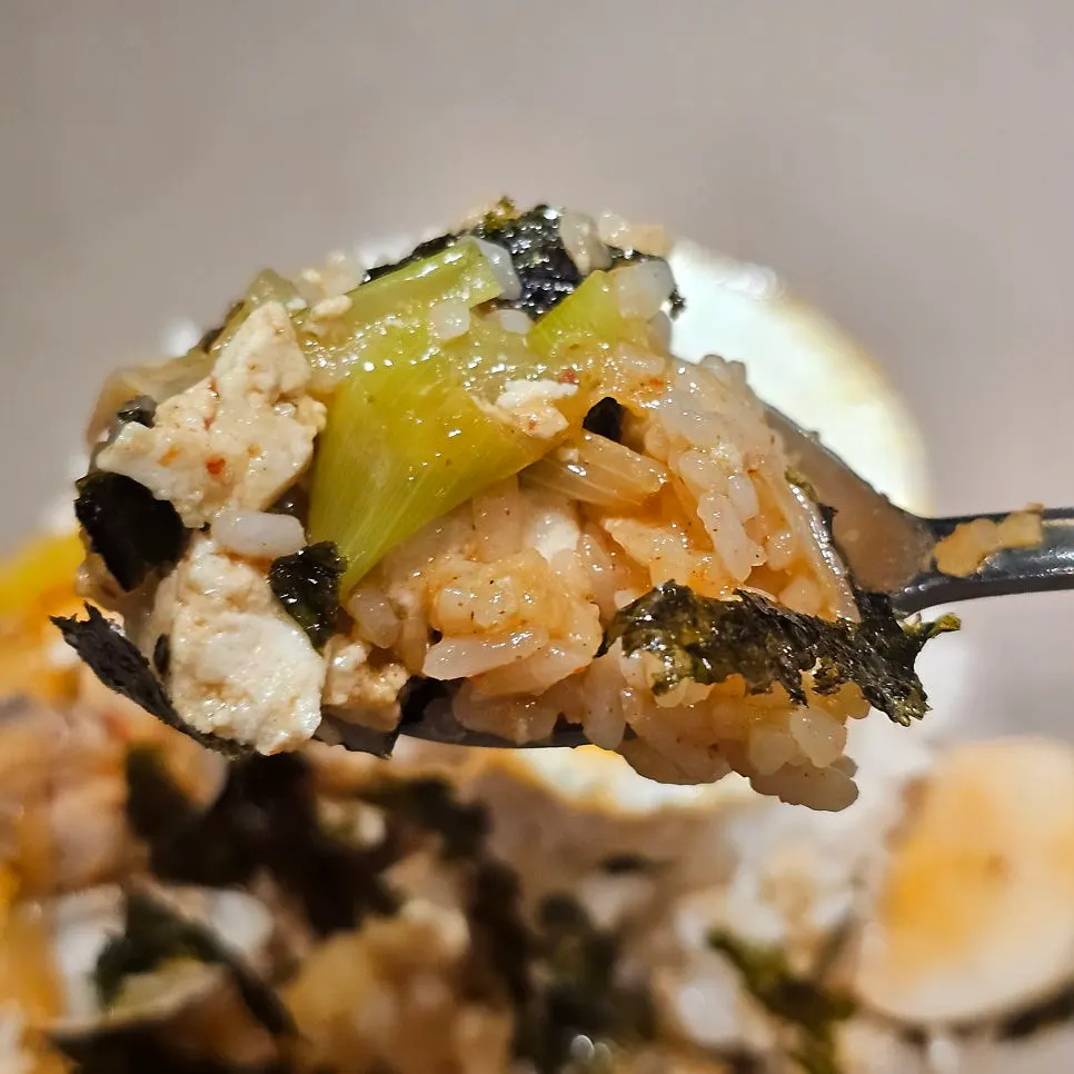 A spoonful of rice mixed with jjageuli broth