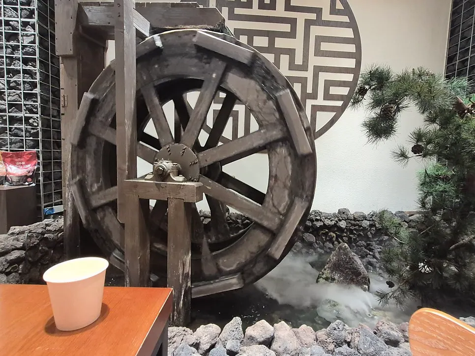Seating area of the Korean restaurant finished with stone and wood