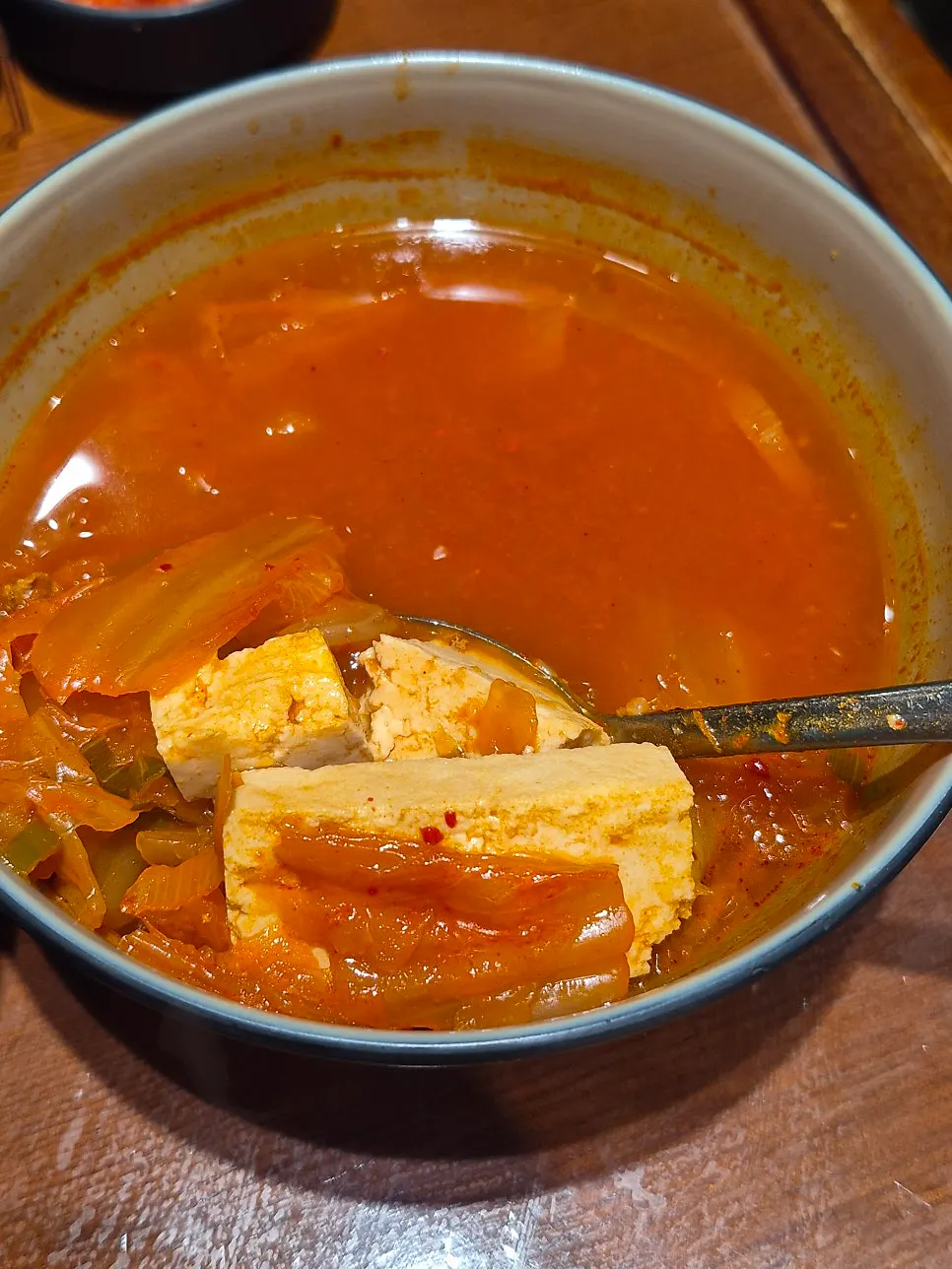 A bowl of kimchi jjigae swapped in for the steamed egg side