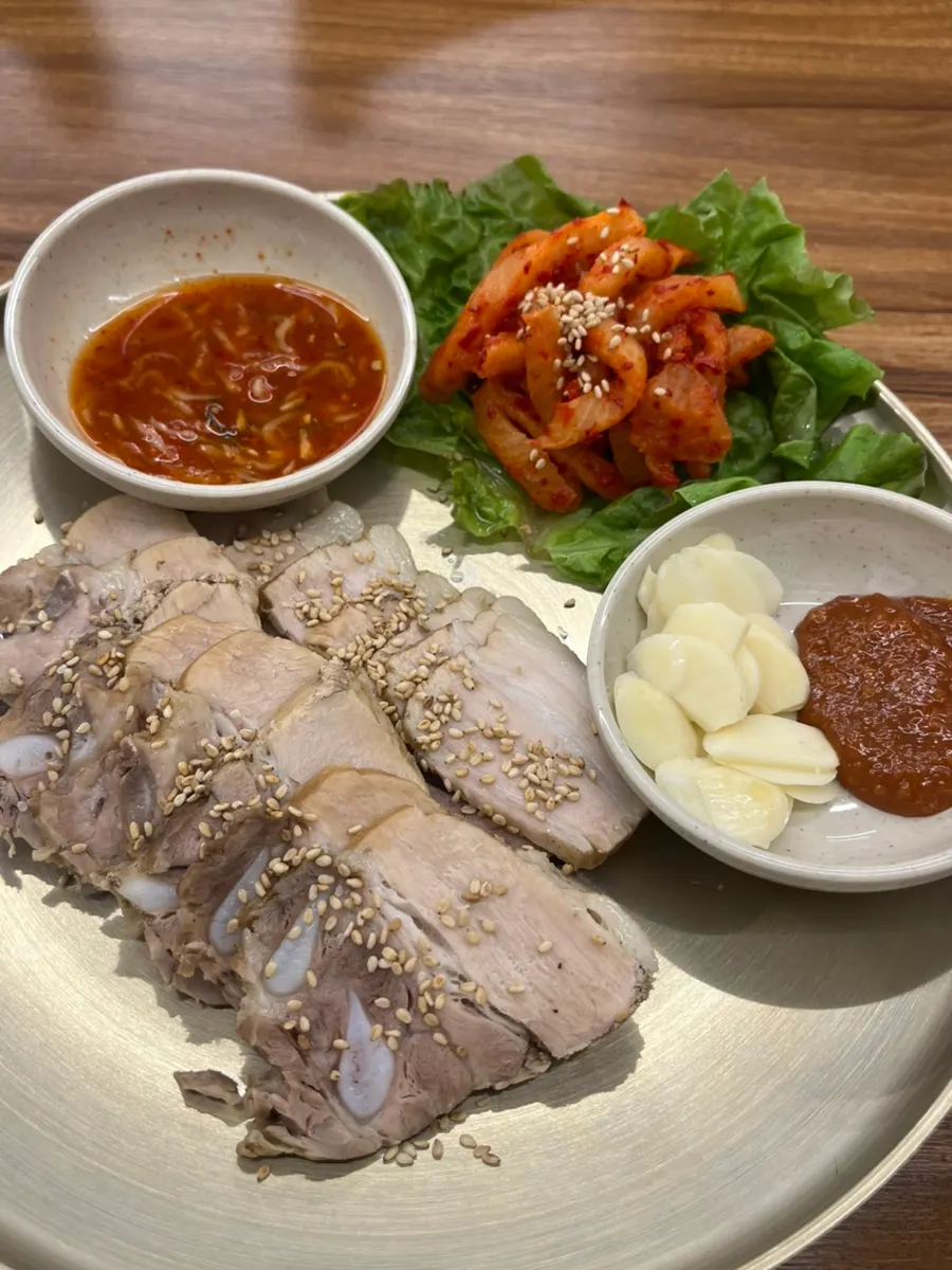 Gangnam bossam served with salted shrimp and mumallaengi salad