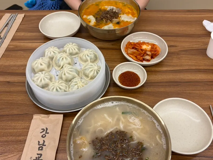 Table spread of kalguksu, dumplings and kimchi
