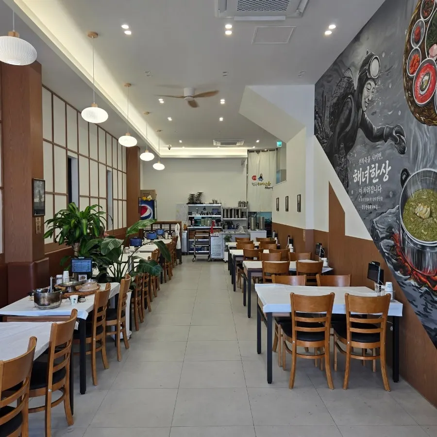 Spacious first-floor interior with many tables at Gangneung Jeonbok Haenyeo Village