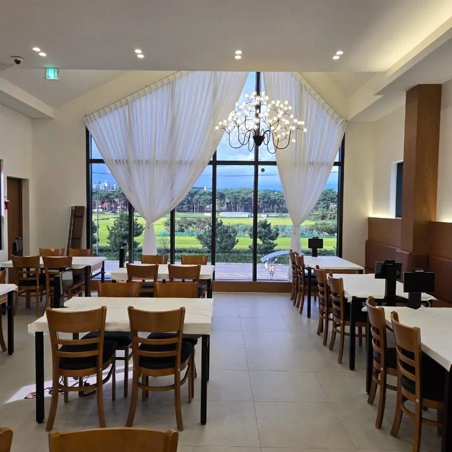 Second-floor seating with floor-to-ceiling windows and lighting