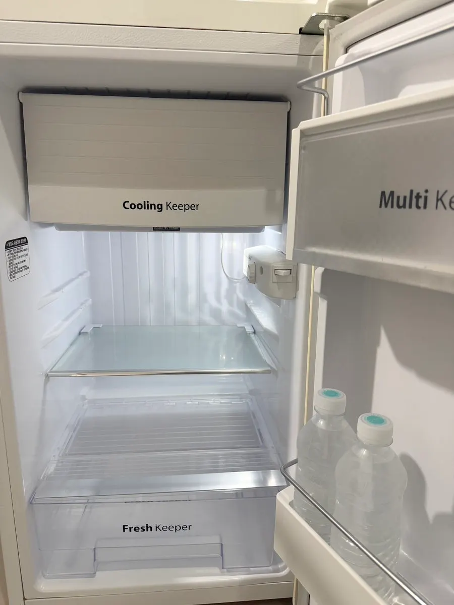 Fridge in Room 401 with two free bottles of water