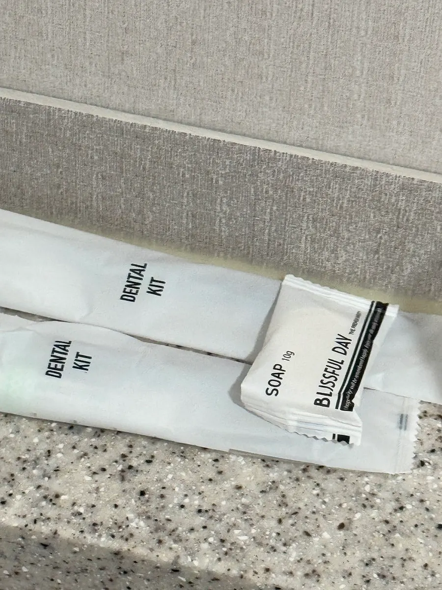 Disposable toothbrush and toothpaste amenities in the bathroom