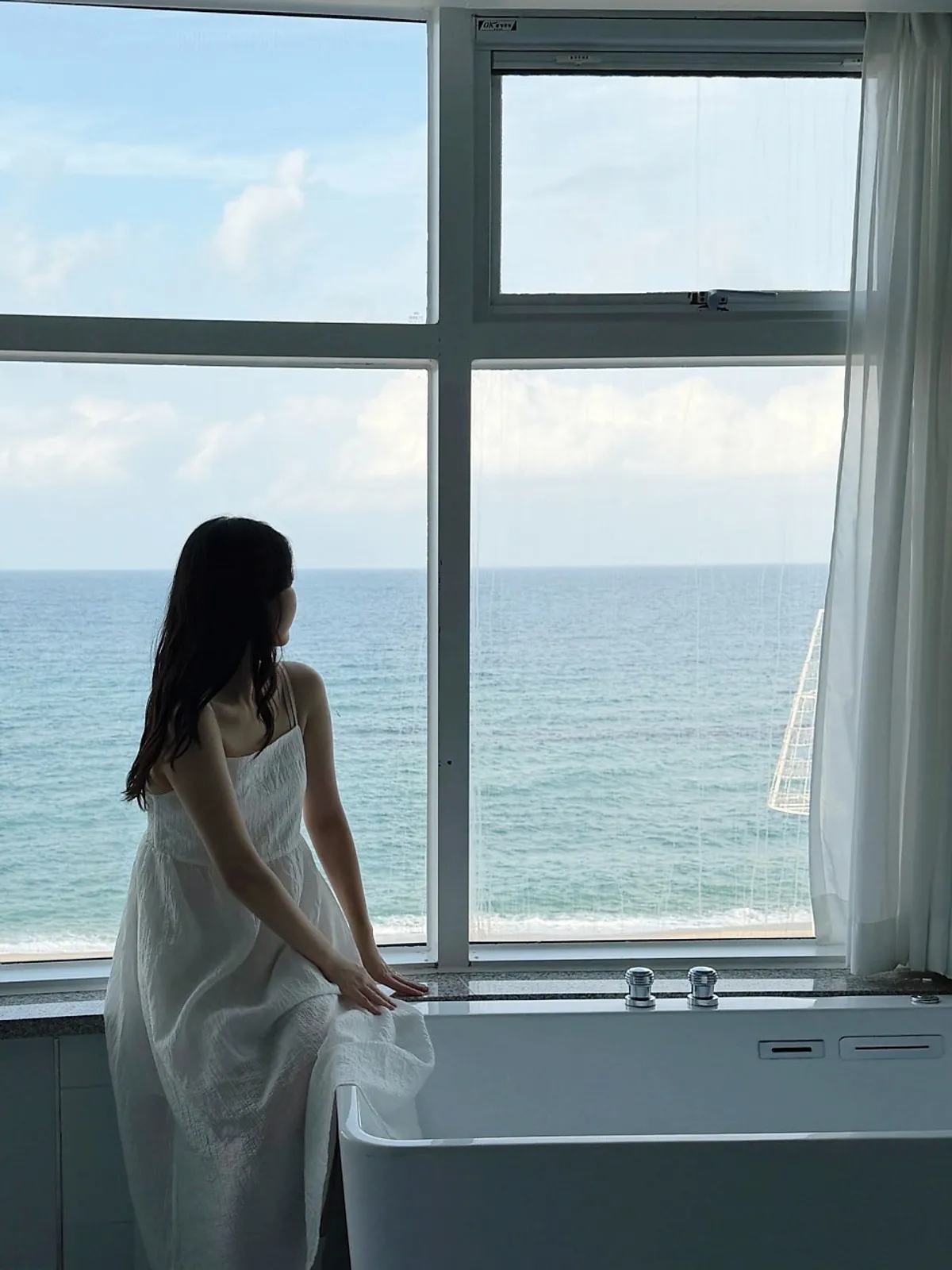Ocean view through the floor-to-ceiling window of a room at Your Anmok's Anmok branch