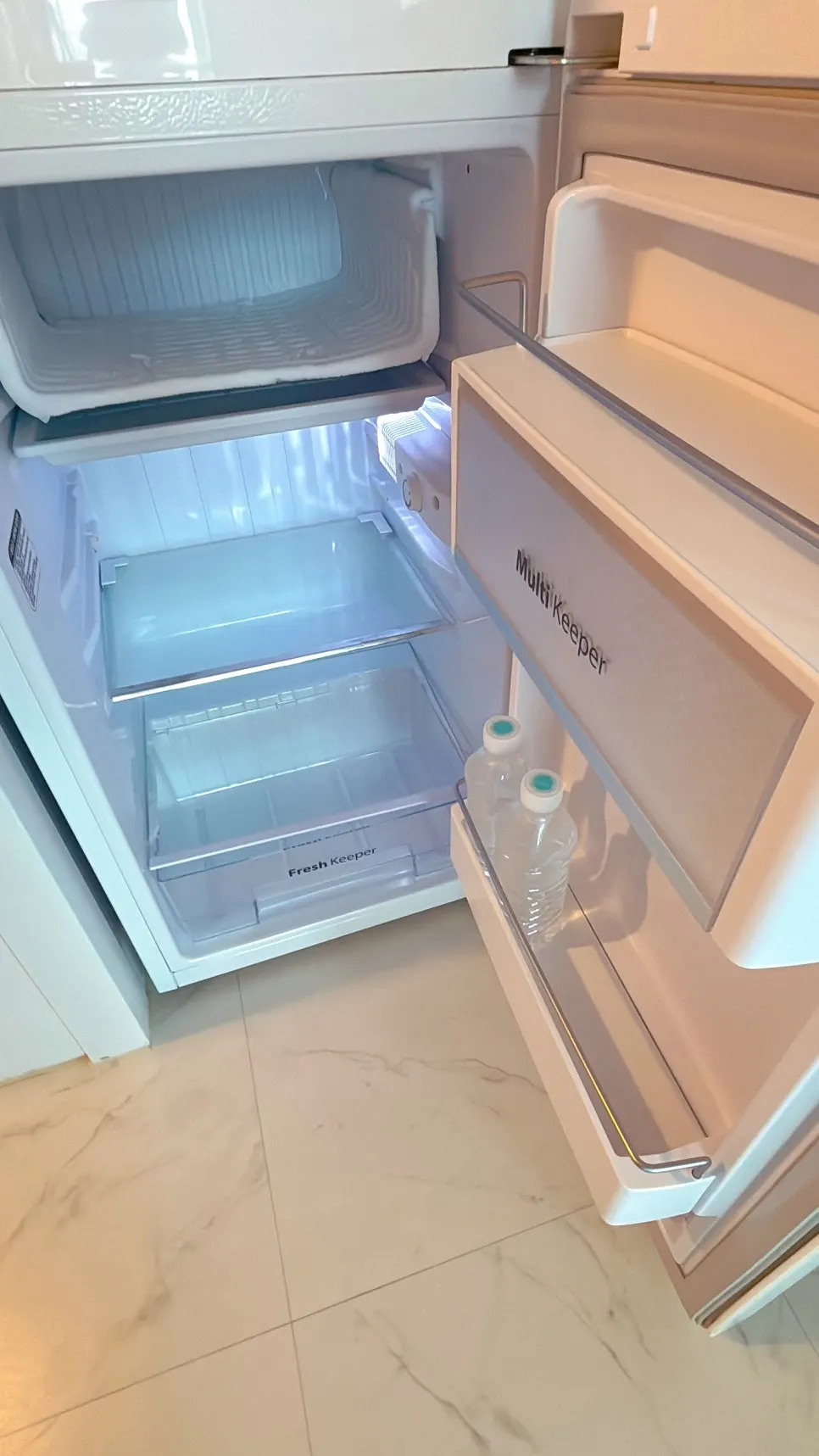 Mini fridge in room 504 with two bottles of water inside