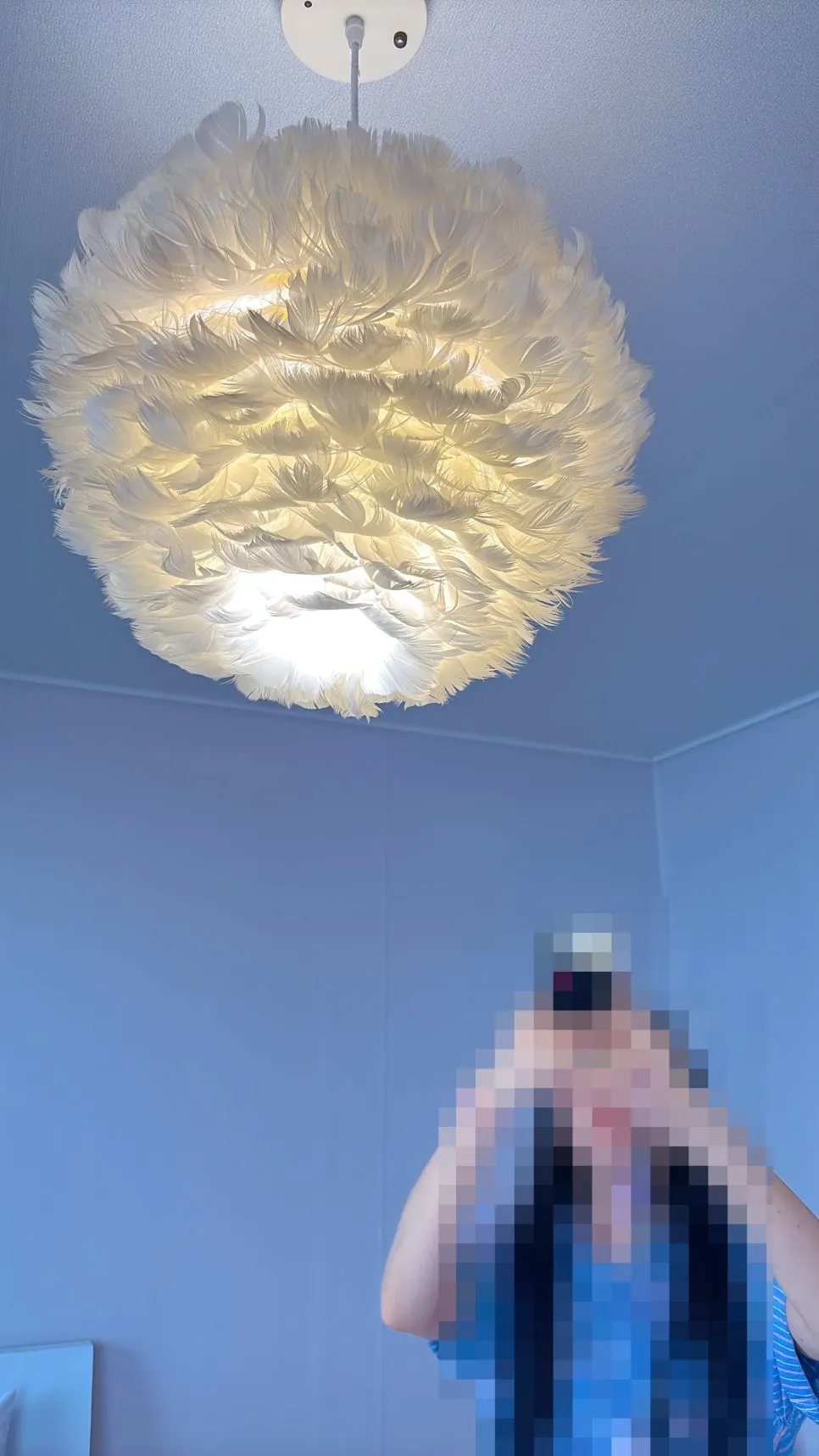 A friend taking a photo under the room's lighting