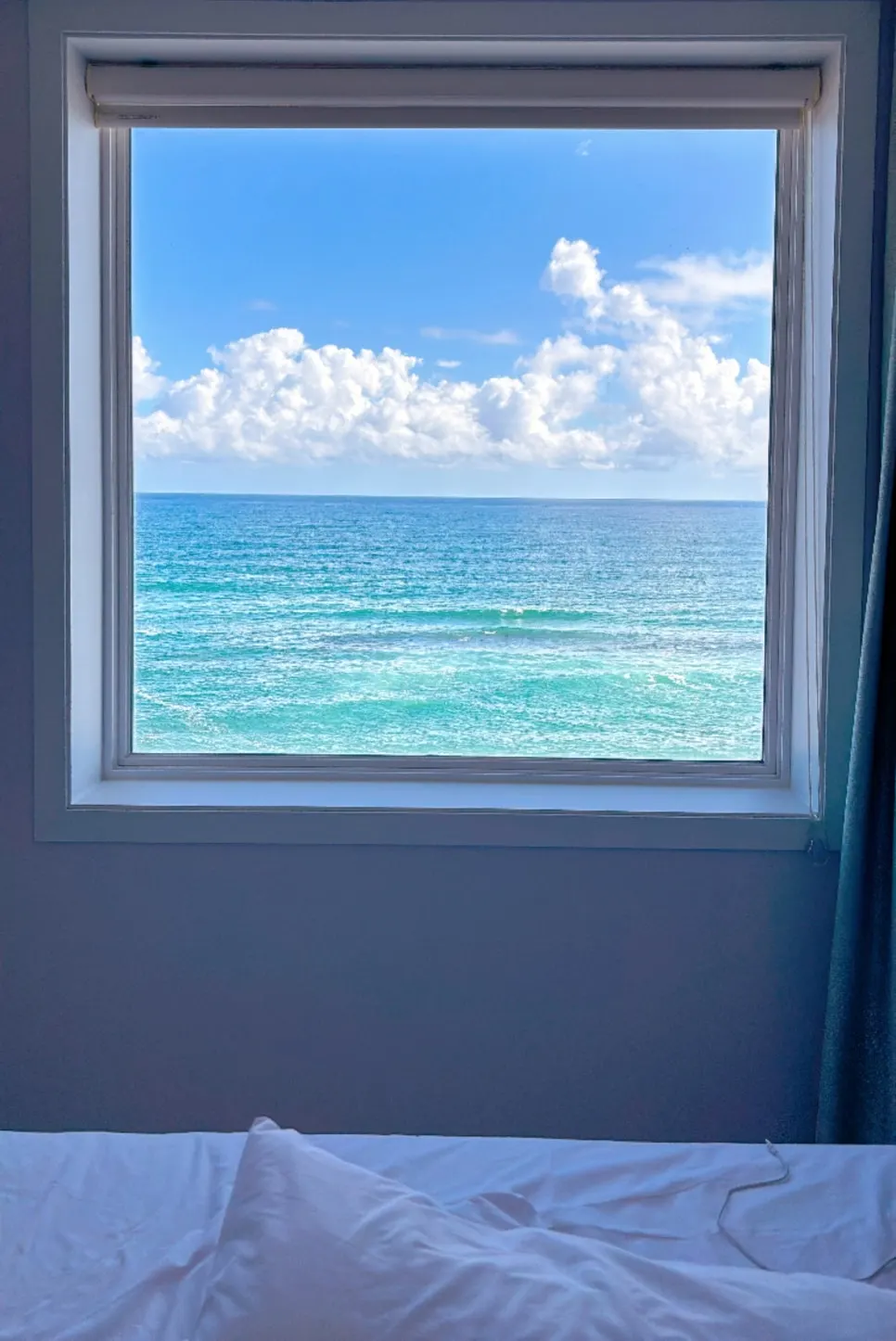 Anmok Beach framed by room 504's window on a clear day-3 morning