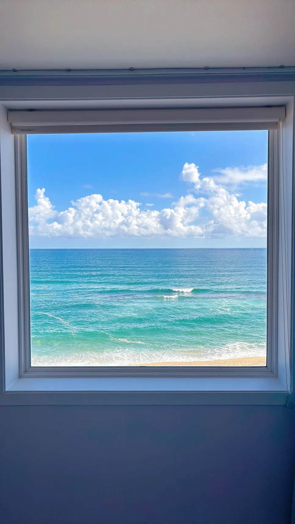 Blue sea and sky seen through the window frame