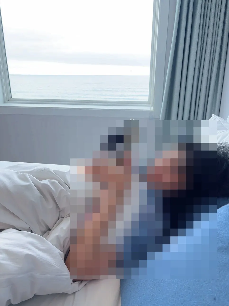 Photo taken lying on the bed with the sea visible beyond