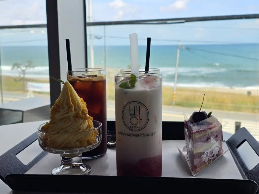 Backlit window shot of drinks with the sea in the background