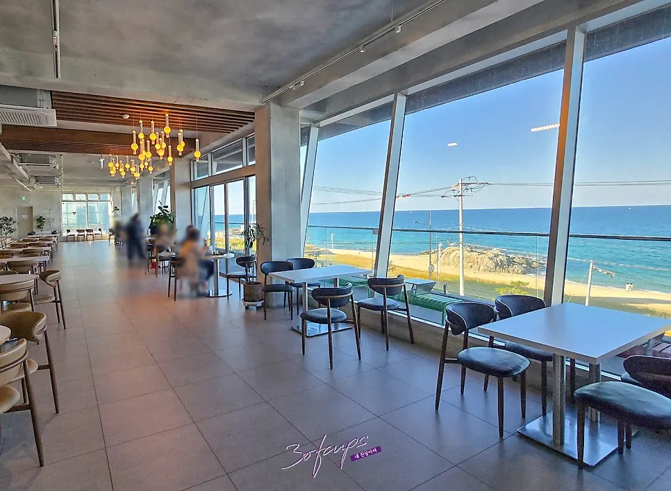 View of Sageunjin sea through Baegya Coffee's 3rd-floor floor-to-ceiling windows