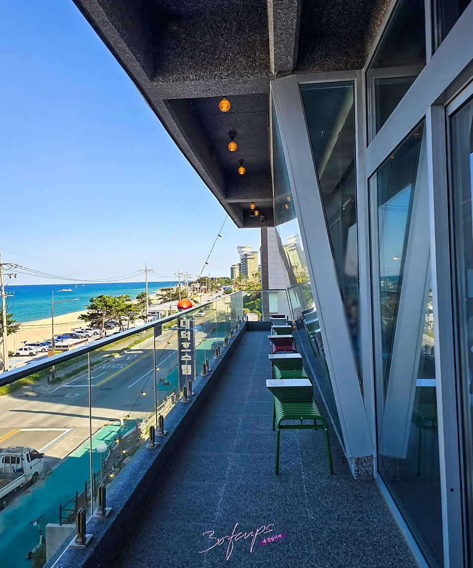 Terrace seating and the sea at Baegya Coffee on a clear day