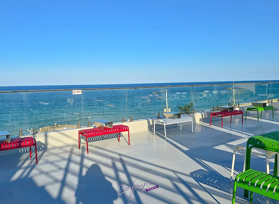 Colorful tables and chairs on Baegya Coffee's rooftop