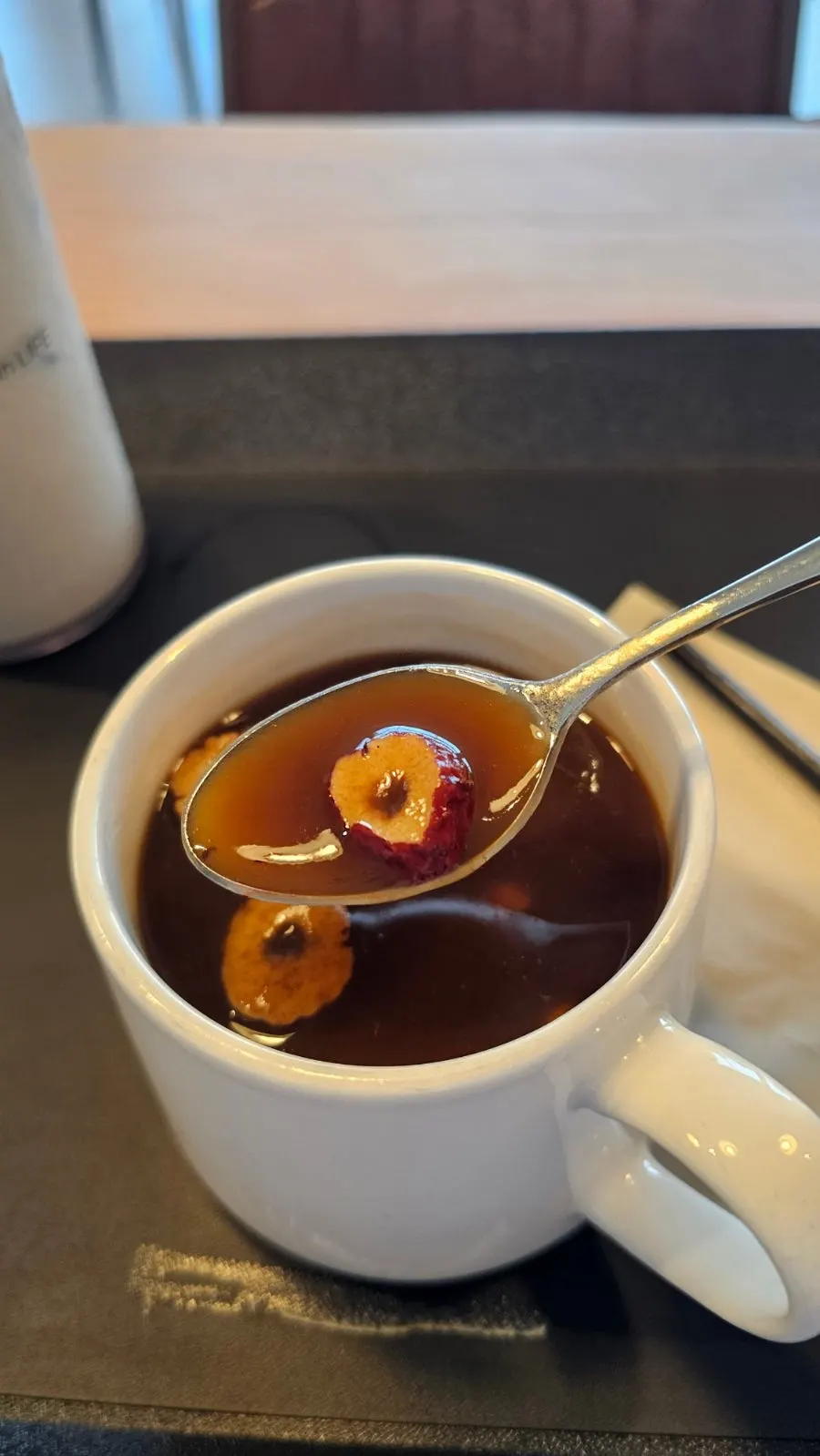 Handmade jujube tea topped with pine nuts and jujube chips