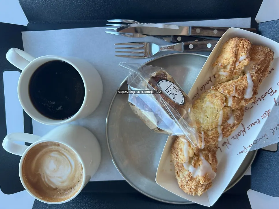 Tray spread of warm coffee and bakery items