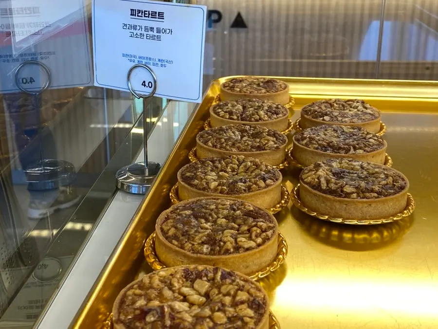 Bread display case with name tags at Baegya Coffee