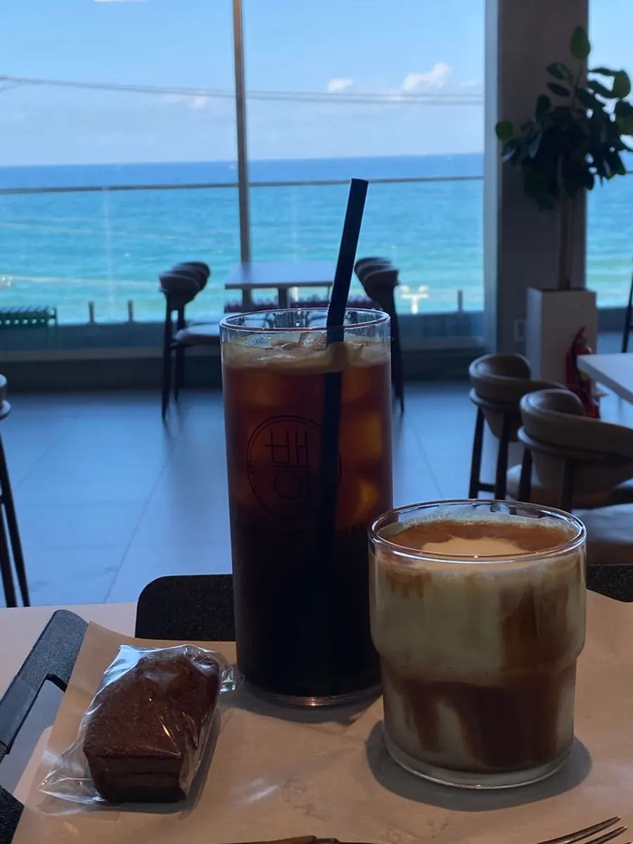 Vertical photo of the iced americano and corn cream shot latte