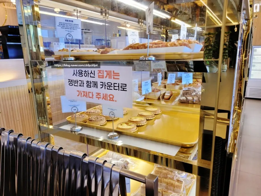Bread arranged in the bakery display case at Baegya Coffee