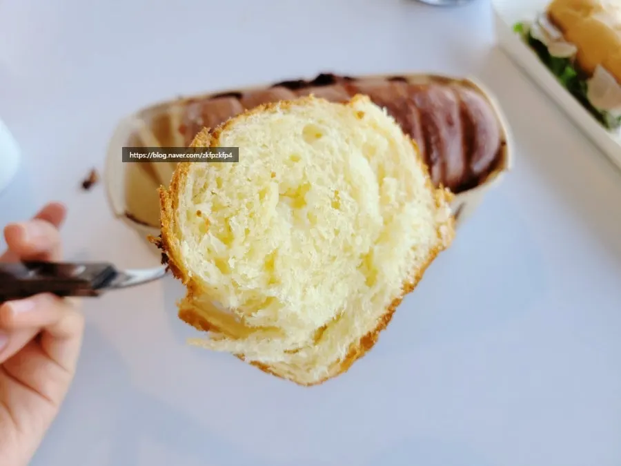 Ingredients visible inside a bitten French reserve sandwich