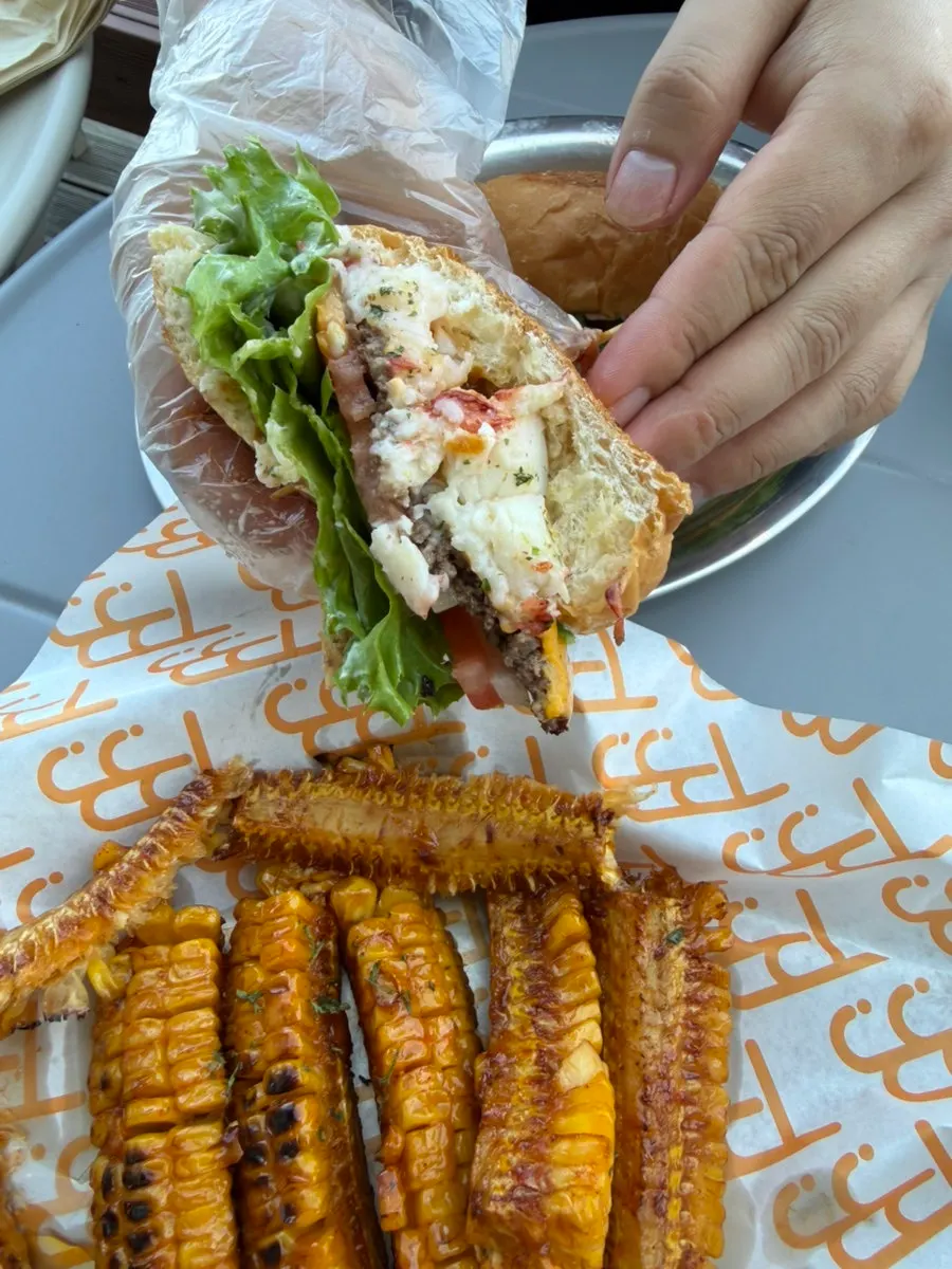 Lobster burger topped with the shell sauce