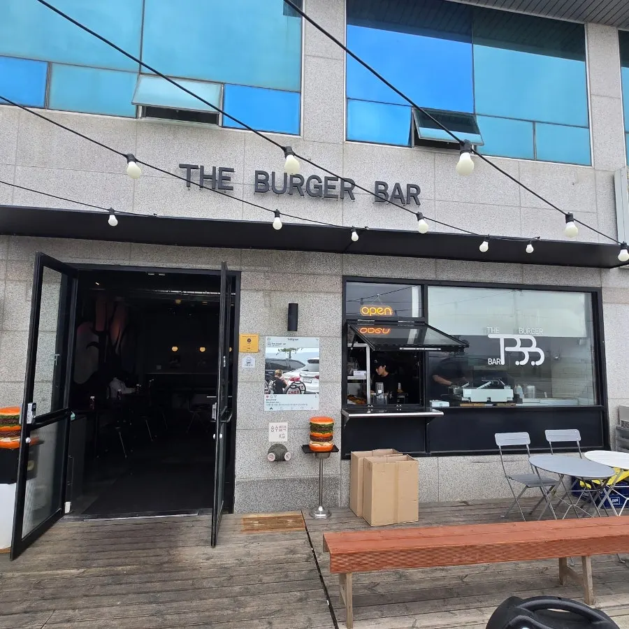 Burger Bar entrance on the first floor of the Ara Pension building with parking space out front