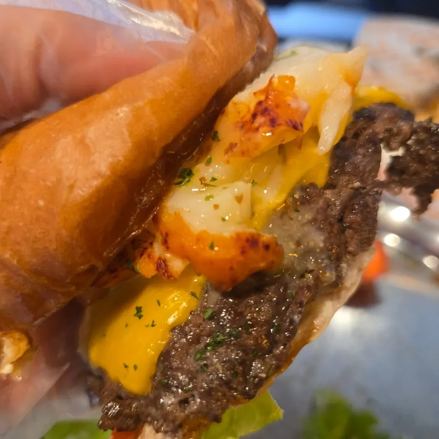 Close-up of a bite taken out of the lobster burger