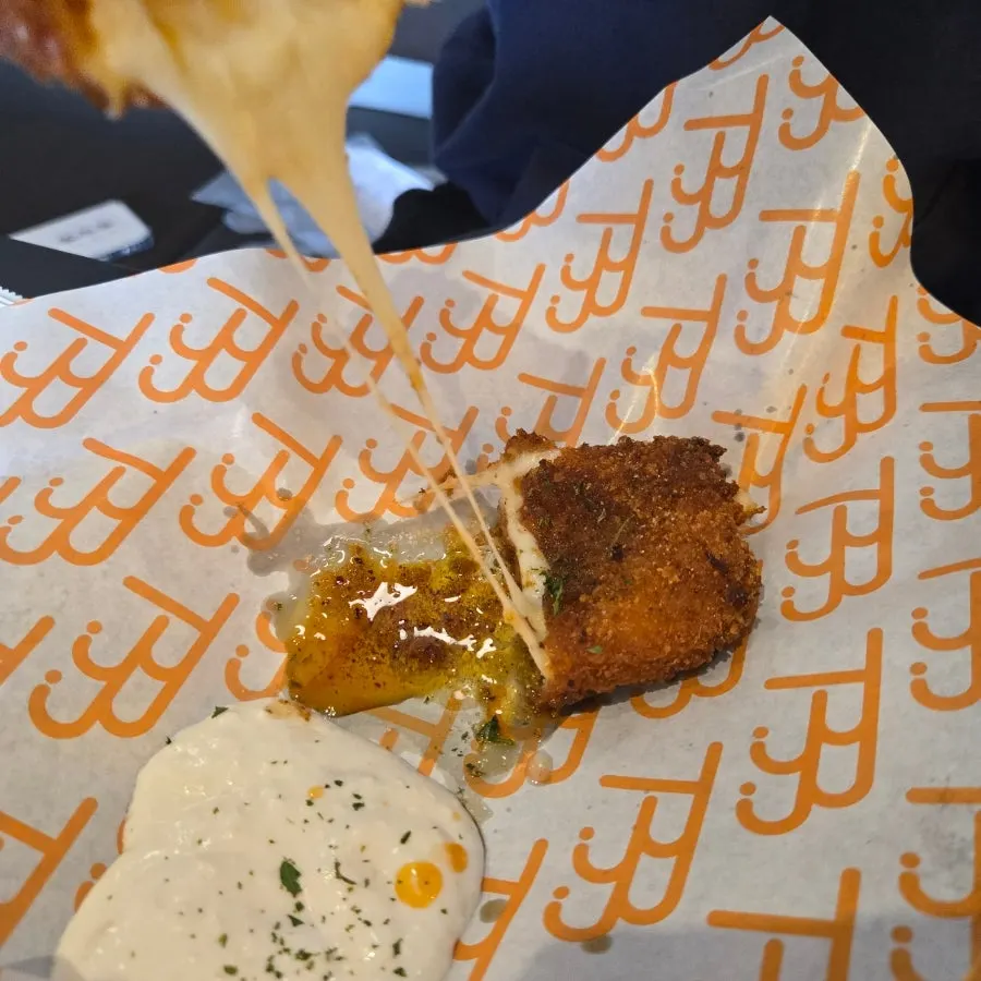 Cheese stretching from the chili corn dog