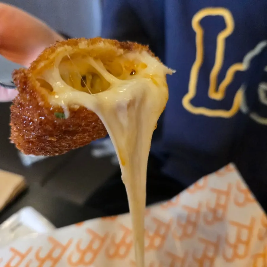 Plate of chili corn dog served with dipping sauce