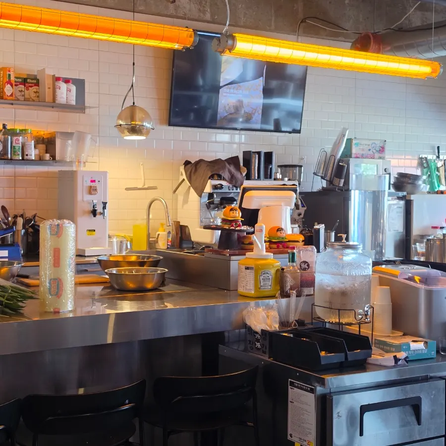 Open kitchen at Burger Bar with a patty being grilled
