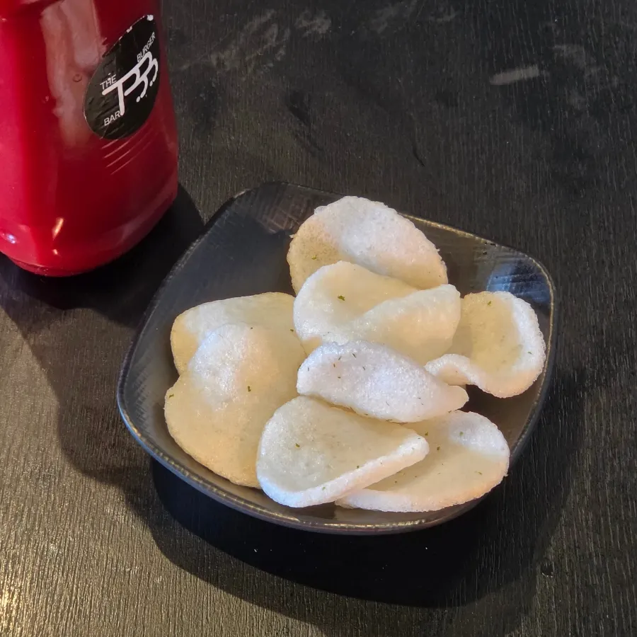 Fish chips dipped in ketchup