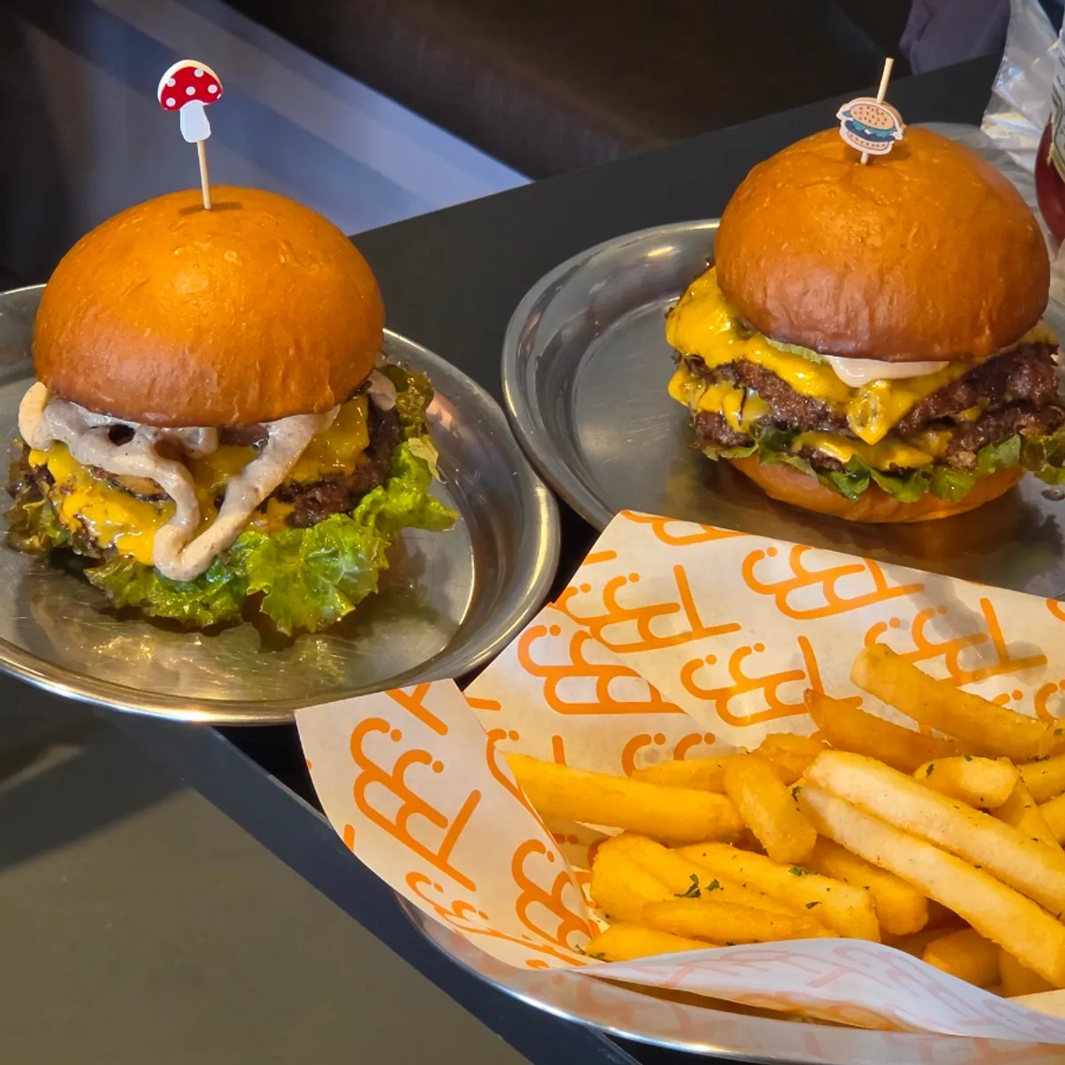 Table set with the Daegwallyeong Songgo Mushroom Burger and Triple Cheese Burger