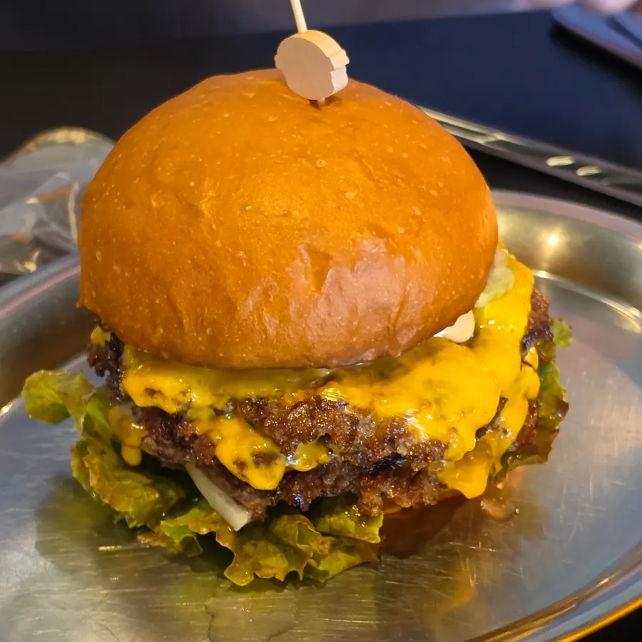 Triple Cheese Burger with three patties stacked inside