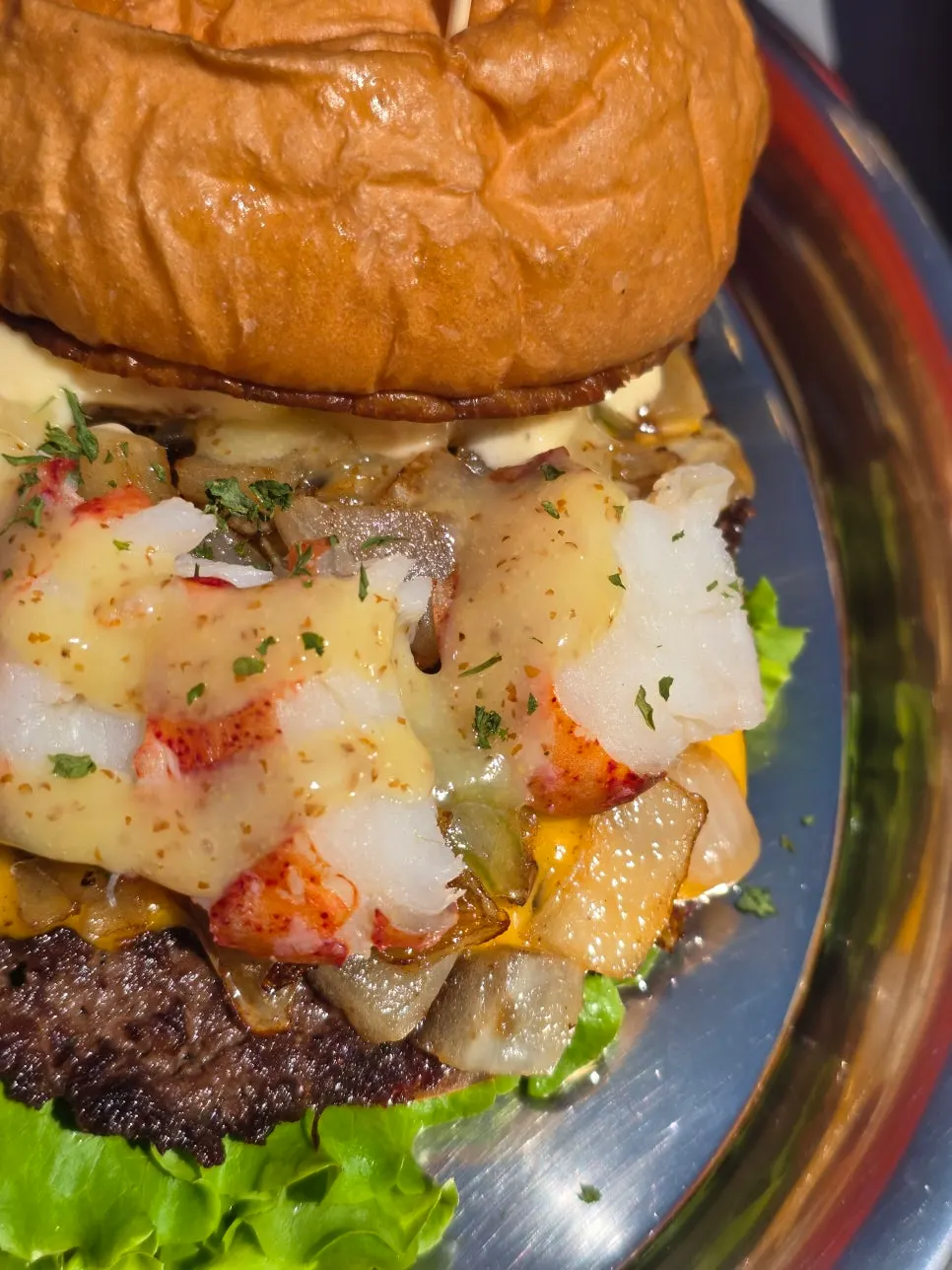Lobster burger with a claw-shaped pick stuck in it