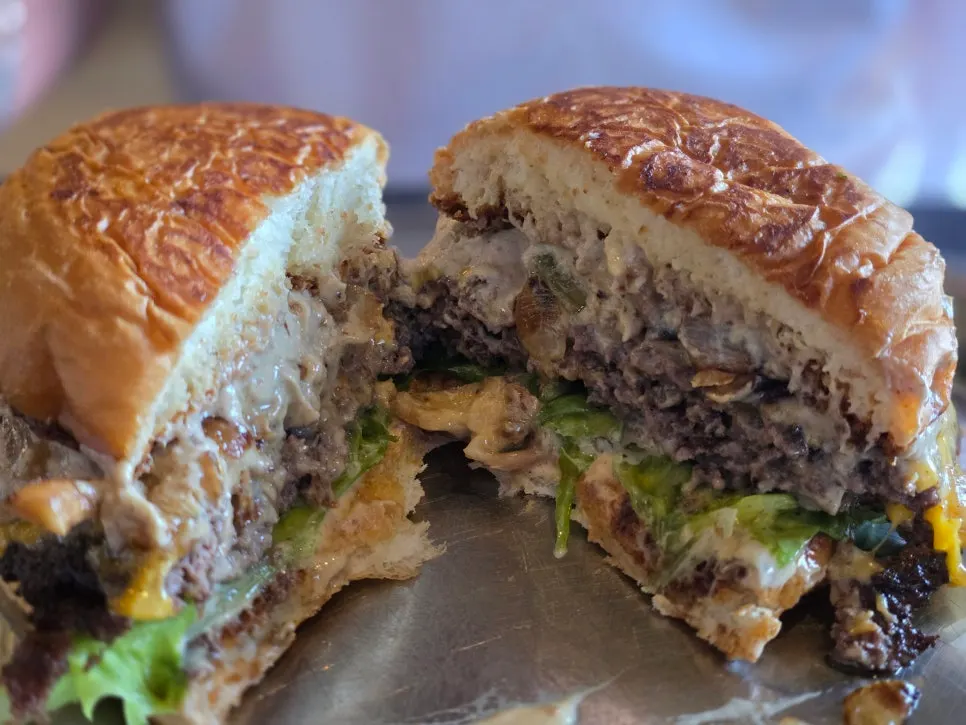 Cross-section showing patty, sautéed onion, and cheese layers